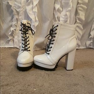 White lace up heel pleather boots.